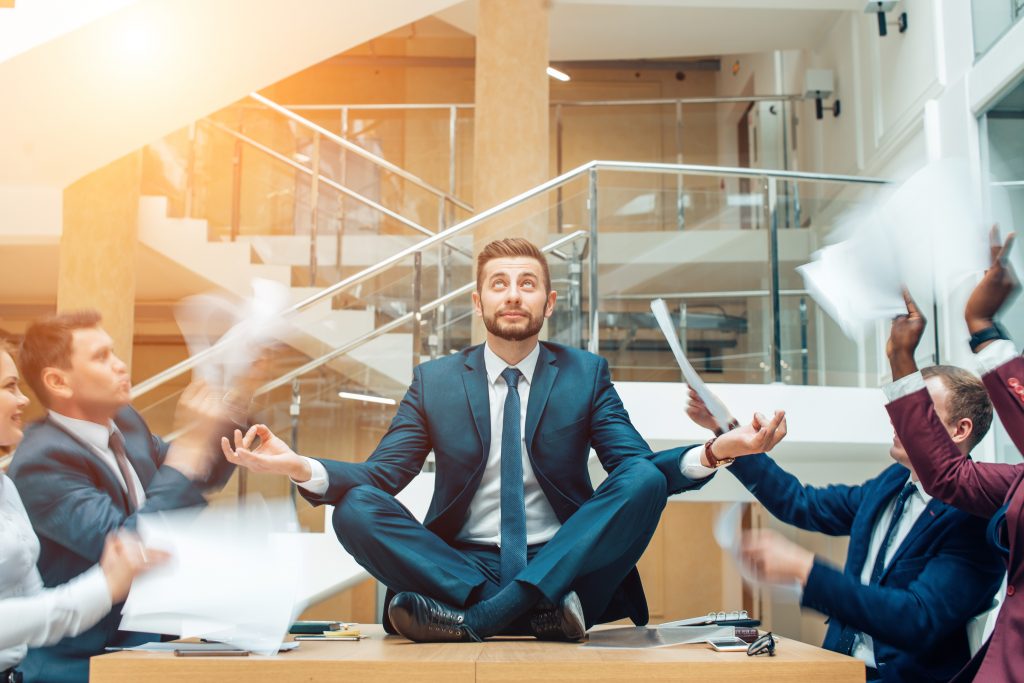 young handsome business man in black suit practice yoga and relax at office while representing stress control concept